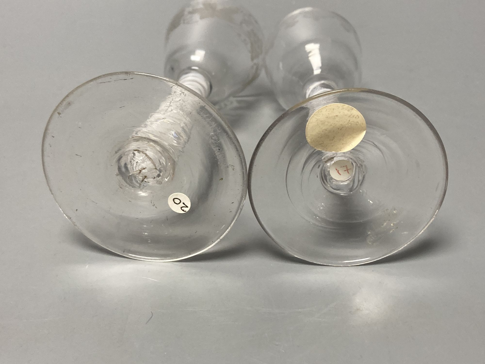 Two George III double series opaque twist stem cordial glasses, c.1760-70, with wheel engraved funnel and ogee bowls, 14.7cm and 14cm
